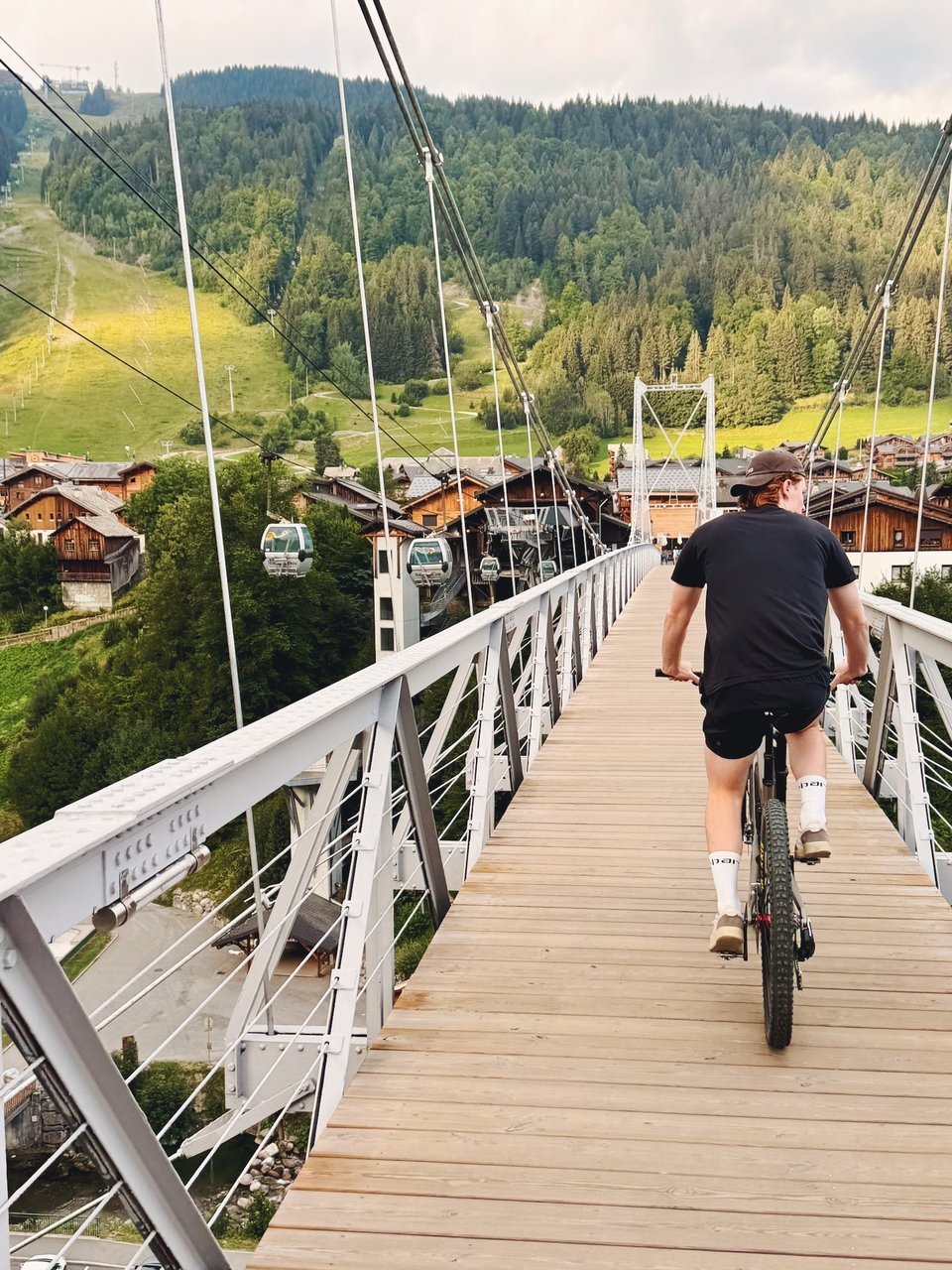 Riding a mountain bike across a wooden bridge